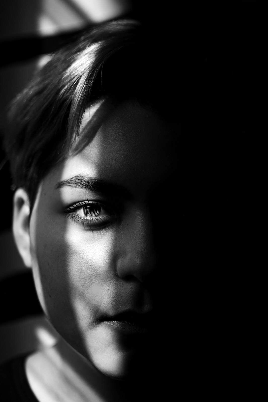 Close, black-and-white study of a subject’s eye and brow