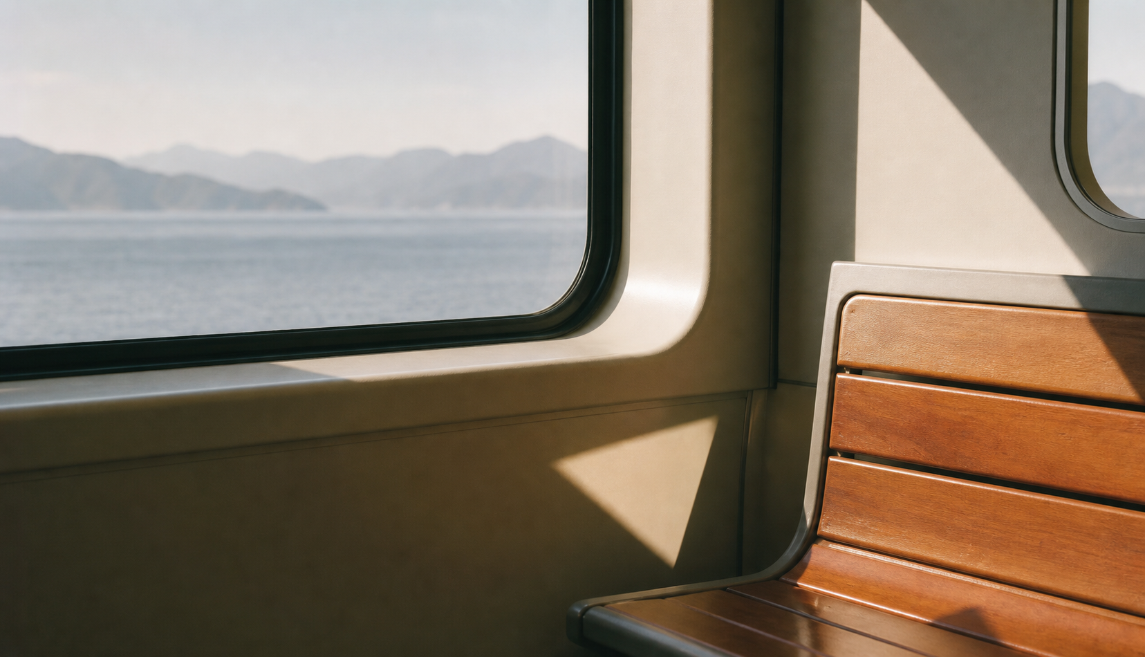 Sunlight on a ferry window and wooden seat